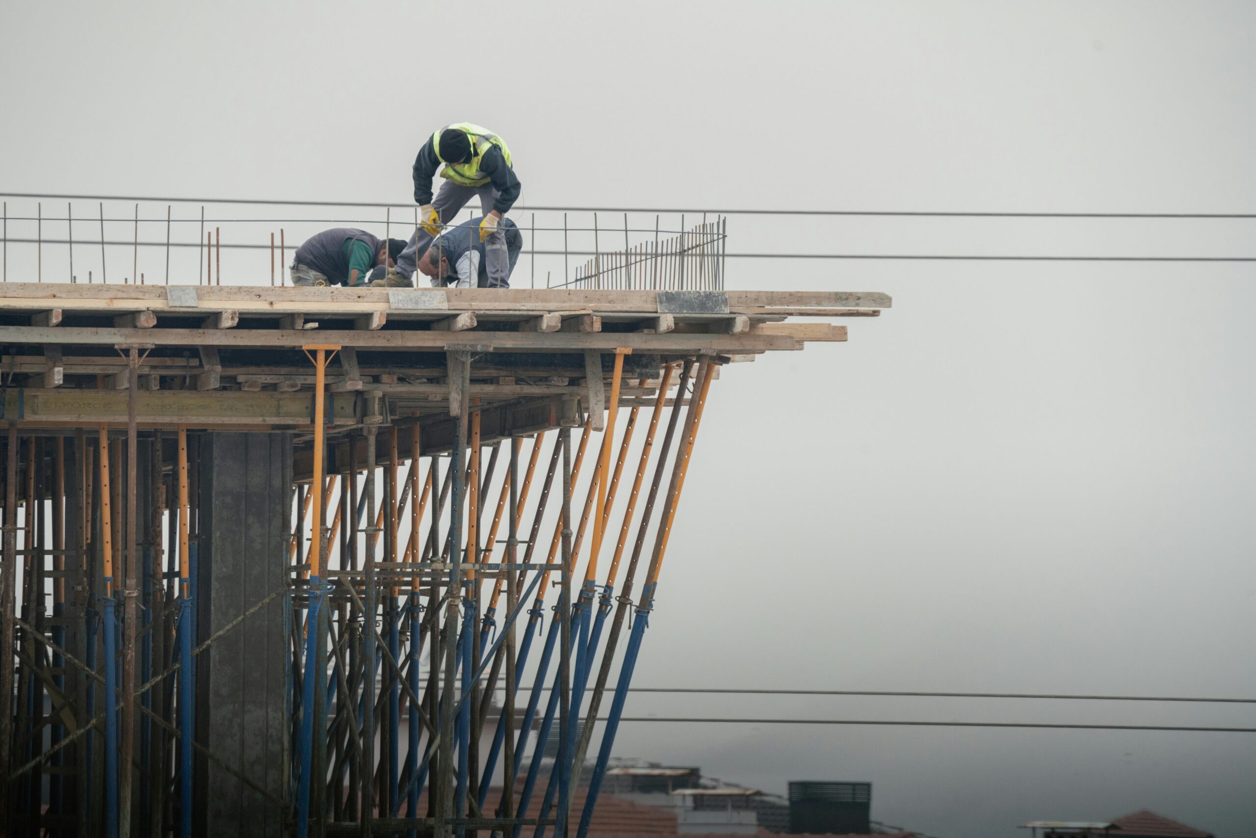 Workers on a high-rise building construction site in Denizli, Türkiye, showcasing teamwork and safety.